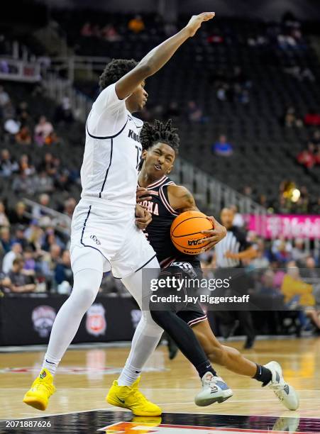 Javon Small of the Oklahoma State Cowboys drives against Marchelus Avery of the UCF Knights during the second half of the Big 12 Men's Basketball...