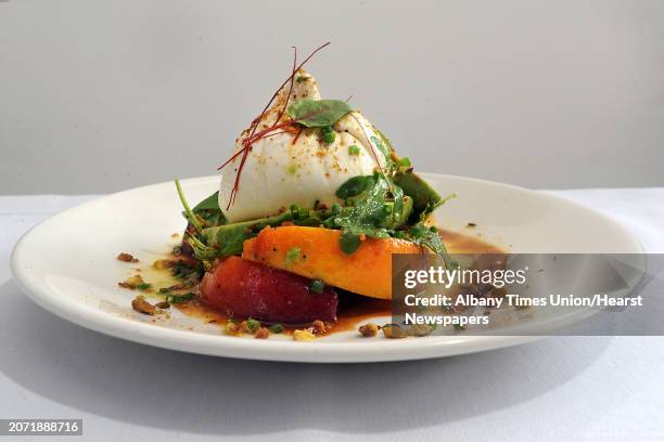 Maple Brook Farms Buratta with marinated peaches, avocados, wild arugula, toasted pistachios and lemon-lime honey dressing at 15 Church restaurant on...