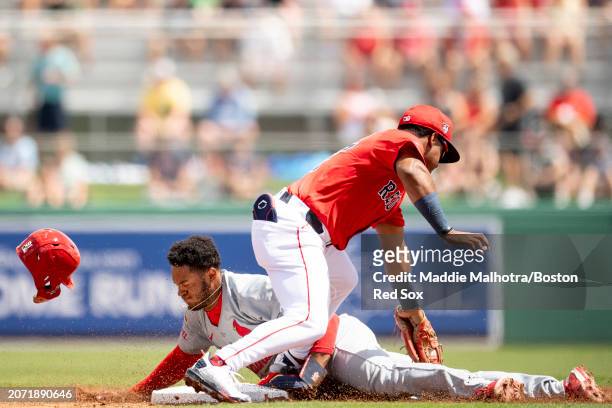 Enmanuel Valdez of the Boston Red Sox tags out a runner during a Spring Training game against the St. Louis Cardinals at JetBlue Park at Fenway South...