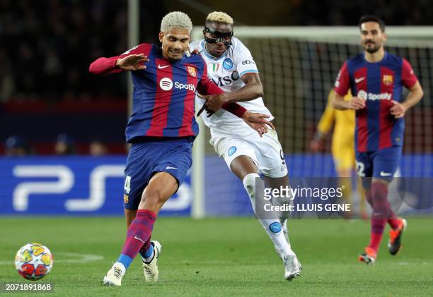 Napoli's Nigerian forward Victor Osimhen challenges Barcelona's Uruguayan defender Ronald Araujo during the UEFA Champions League last 16 second leg...