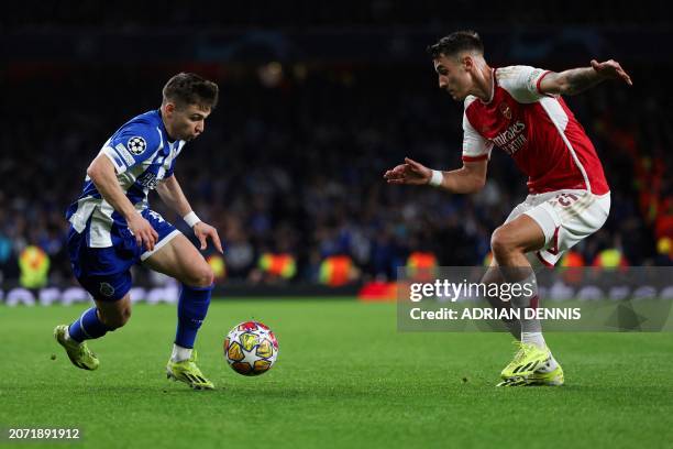 Porto's Portuguese striker Francisco Conceicao fights for the ball with Arsenal's Polish defender Jakub Kiwior during the UEFA Champions League last...