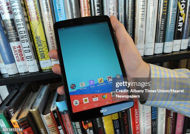 Library clerk Tim Furgal holds a borrowable tablet at the Albany Public Library on Tuesday, Nov. 24, 2015 in Albany, N.Y. The Samsung Galaxy Tab 2...