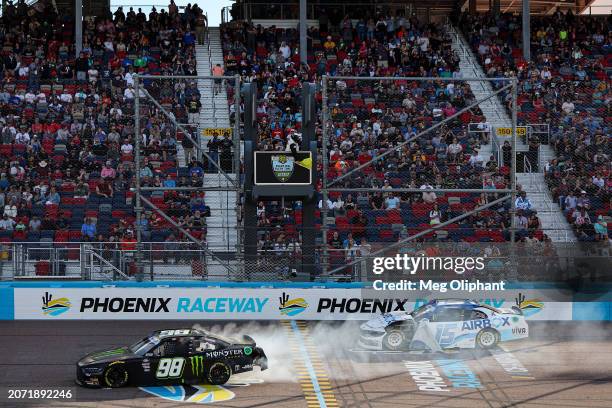 Riley Herbst, driver of the Monster Energy Ford, and Hailie Deegan, driver of the AirBox Ford, spin after an on-track incident during the NASCAR...