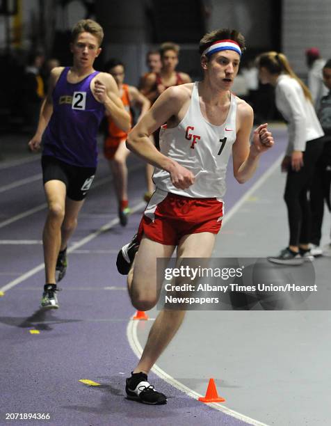 Glens Falls sophomore Chris Hughes, right, leads the pack and wins the boys 3200 meter during the section II indoor track state qualifier in the...