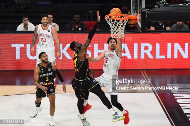 Ismet Akpinar of Galatasaray Ekmas goes to the basket against Eddy Edigin of Riesen Ludwigsburg during the FIBA Champions League Group J match...