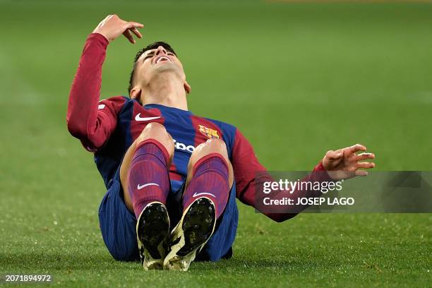 Barcelona's Portuguese defender Joao Cancelo reacts during the UEFA Champions League last 16 second leg football match between FC Barcelona and SSC...