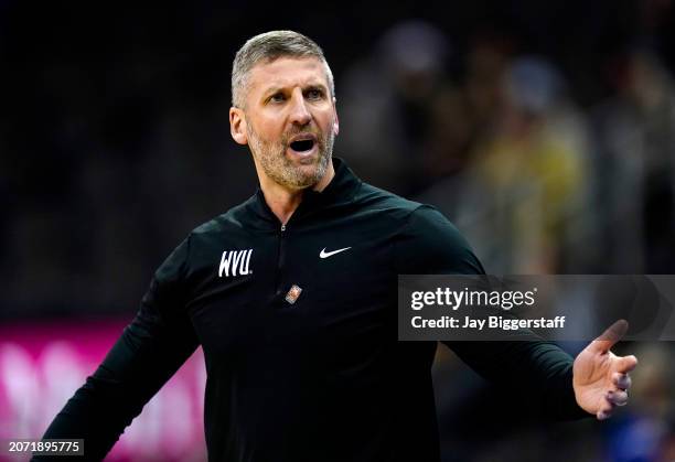 Head coach Josh Eilert of the West Virginia Mountaineers reacts during the second half against the Cincinnati Bearcats of the Big 12 Men's Basketball...