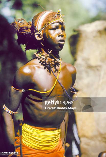 Young Samburu man dances a dance of welcome at a remote Samburu village in Samburu National Reserve, Kenya, East Africa, 2000. .