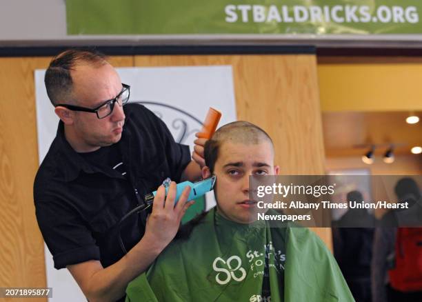 Patrick Driscoll of Syracuse gets his head shaved by Mark Jablonski of Patsy's Barber Shop to raise funds for St. Baldrick's Foundation at The...