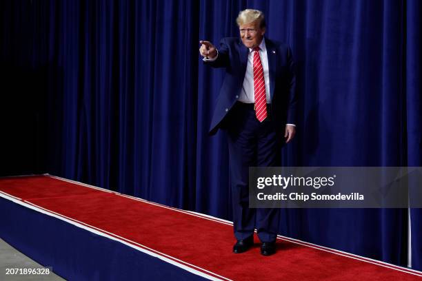 Republican presidential candidate and former U.S. President Donald Trump takes the stage during a campaign rally at the Forum River Center March 09,...