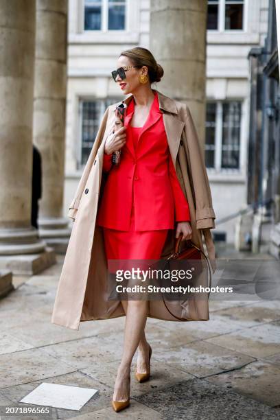 Alexandra Lapp is seen wearing a Comma trench coat in sand, a Comma blazer in coral, a Comma top in coral, a Comma skirt in coral, For Art's Sake...