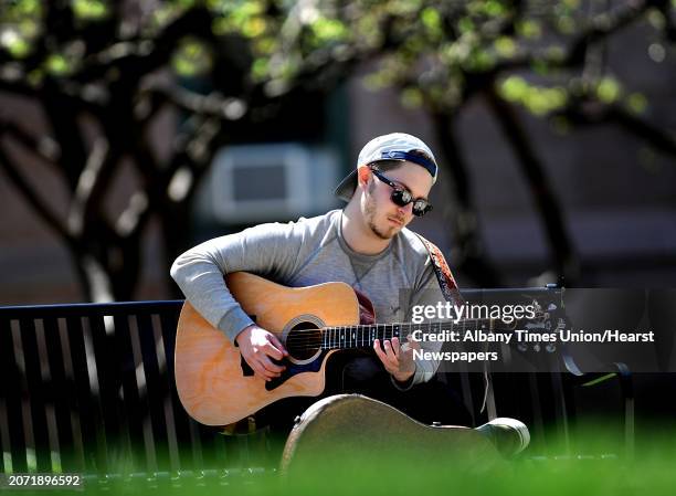 Sage College student Andrew Clifford of Rotterdam practices music on his guitar between classes on the Sage College campus Wednesday, April 120, 2016...