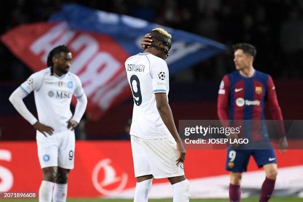 Napoli's Nigerian forward Victor Osimhen reacts to Barcelona's third goal, scored by Barcelona's Polish forward Robert Lewandowski , during the UEFA...