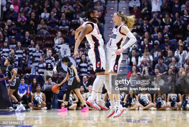 UConn Huskies guard Paige Bueckers react with UConn Huskies guard KK Arnold after making a three point shot during the Women's Big East Tournament...