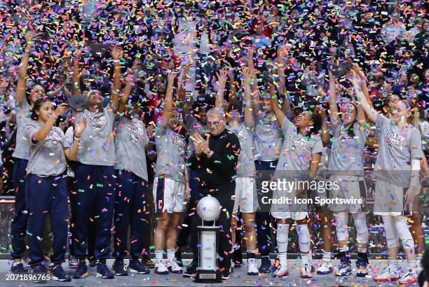 UConn Huskies players celebrate after winning the Women's Big East Tournament championship on March 11 at Mohegan Sun Arena in Uncasville, CT.