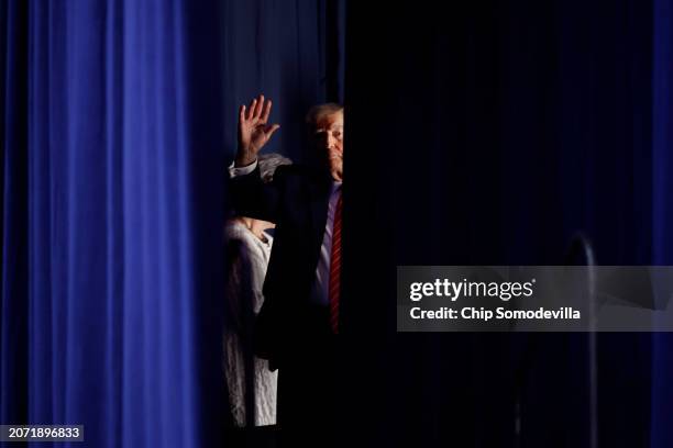Republican presidential candidate and former U.S. President Donald Trump waits to take the stage during a campaign rally at the Forum River Center...