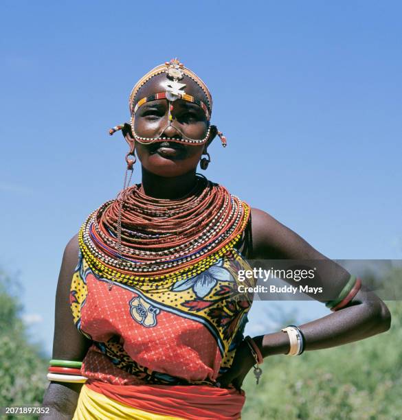 Young Samburu woman dressed in her finest display of beaded necklaces at a remote Samburu village in Samburu National Reserve, Kenya, East Africa,...