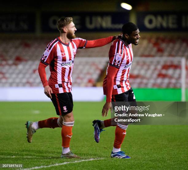 Lincoln City's TJ Eyoma, right, celebrates scoring his side's fifth goal with team-mate Ted Bishop, left, during the Sky Bet League One match between...