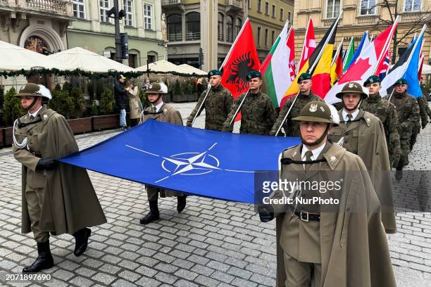 Soldiers carrying NATO flag take part in the ceremony of the 25th nnniversary of joining Poland To NATO in Krakow, Poland on March 12, 2024.