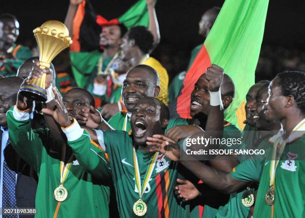 Zambia's national football team players celebrate with the cup after their victory against Ivory Coast at the Stade de l'Amitie in Libreville on...