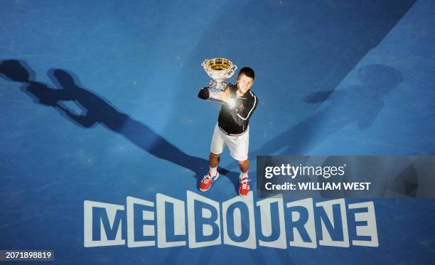 Novak Djokovic of Serbia poses with the trophy after his victory over Rafael Nadal of Spain in the men's final match on day 14 of the 2012 Australian...