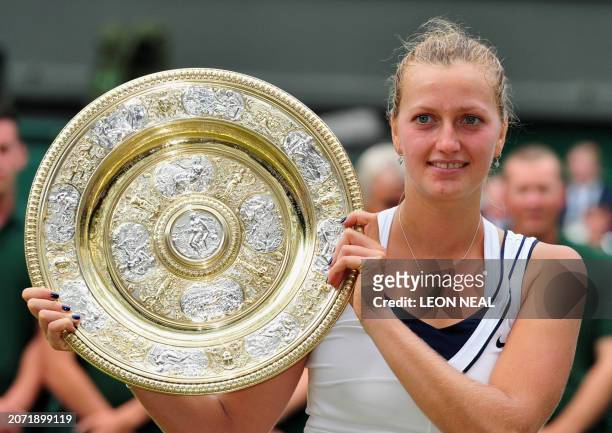 Czech player Petra Kvitova celebrates with the trophy after beating Russia's Maria Sharapova in the Women's Final of the 2011 Wimbledon Championships...