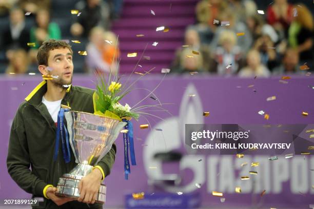 Marin Cilic of Croatia celebrates with the trophy after beating Janko Tipsarevic of Serbia in the final of the St. Petersburg Open tennis tournament...