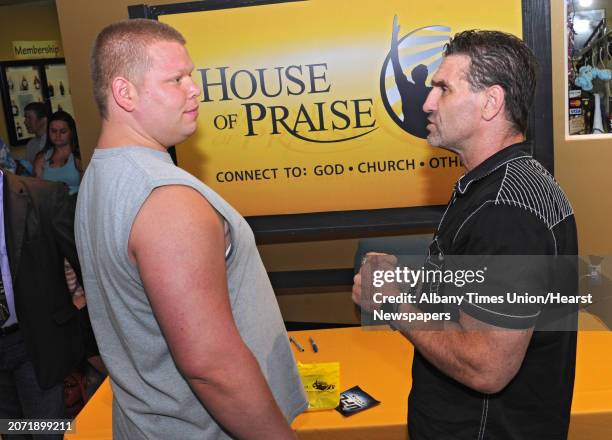 Warren Ogren of Albany, left, talks to UFC legend Ken Shamrock after the fighter talked about his journey at the House of Praise on Sunday, June 19,...