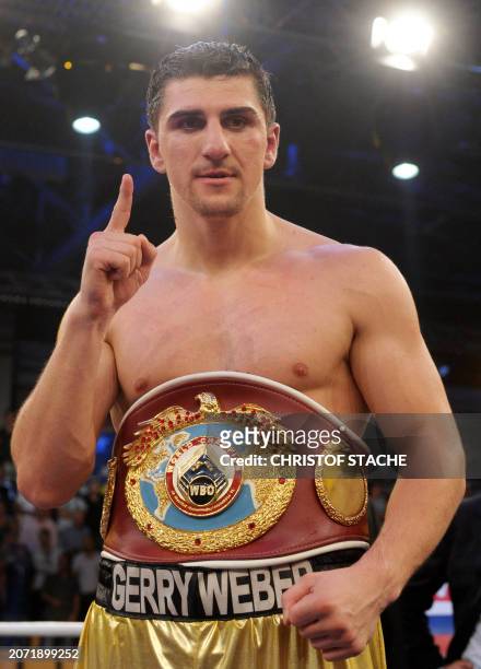 German Marco Huck celebrates with the champions' belt after his victory over Argentinian Hugo Hernan Garay in their WBO cruiserweight world champion...