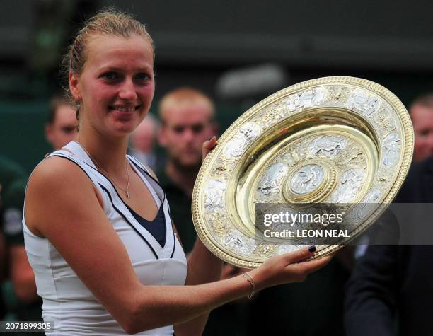 Czech player Petra Kvitova poses for pictures with the trophy after beating Russia's Maria Sharapova in the Women's Final of the 2011 Wimbledon...