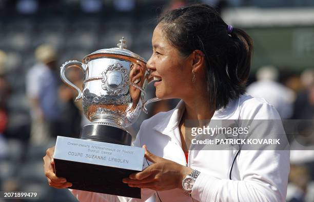 China's Li Na kisses the trophy after winning over Italy's Francesca Schiavone during their Women's final in the French Open tennis championship at...