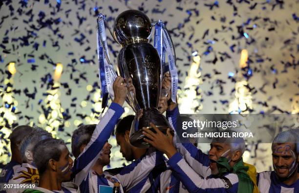 Porto's players hold the trophy as they celebrate after they won the Portuguese Super League 2010-2011 at the end of their football match against...