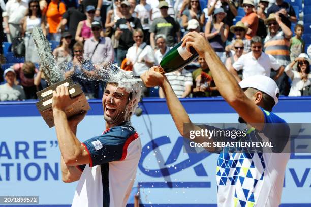 Spain's Fernado Verdasco sprays fellow Spaniard Marcel Granollers with champagne to celebrate his opponent's victory at the Swiss Open ATP tennis...