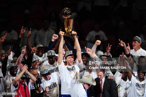 Dirk Nowitzki of the Dallas Mavericks celebrates with teammates after winning the NBA Finals against the Miami Heat on June 12, 2011 at the...