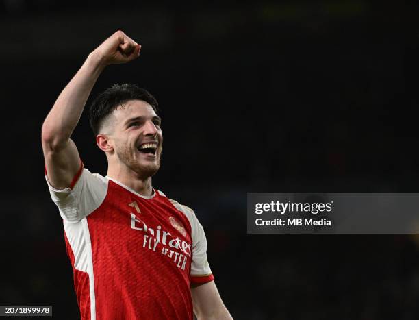 Declan Rice of Arsenal celebrates after winning the penalty shootout for the UEFA Champions League 2023/24 round of 16 second leg match between...