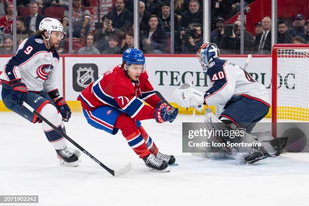 Jake Evans of the Montreal Canadiens skates by Daniil Tarasov of the Columbus Blue Jackets during the first period of the NHL game between the...