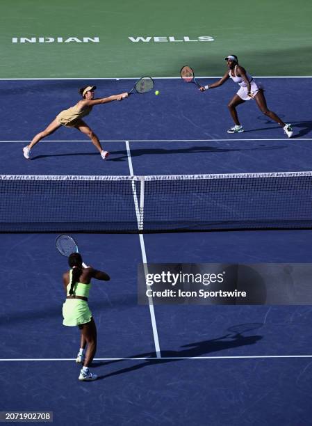 The ball goes between Ena Shibahara and her partner Asia Muhammad during a WTA quarterfinals doubles tennis match played on March 12, 2024 during the...