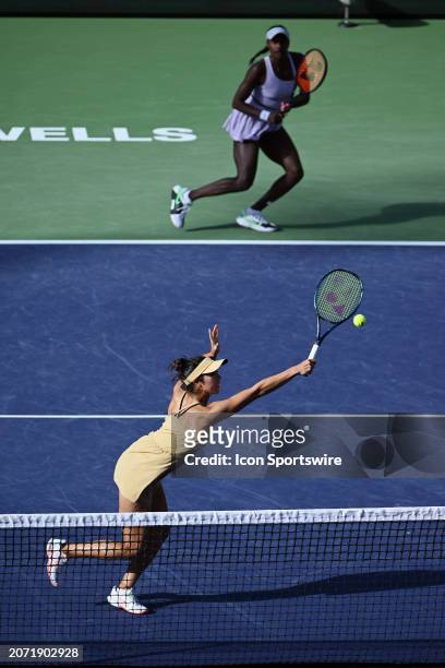Ena Shibahara returns a ball in front of her partner Asia Muhammad during a WTA quarterfinals doubles tennis match played on March 12, 2024 during...