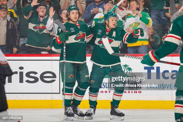 Kirill Kaprizov celebrates his goal with his teammate Brock Faber of the Minnesota Wild against the Arizona Coyotes during the game at the Xcel...