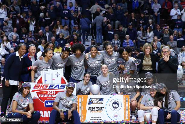 UConn Huskies players pose for pictures after winning the Women's Big East Tournament championship on March 11 at Mohegan Sun Arena in Uncasville, CT.