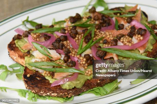 Smoked trout toast - avocado, Vermont smoked trout, pickled onions, crispy capers, mustard seed "caviar" at The Hen & The Hound Bistro on Thursday,...