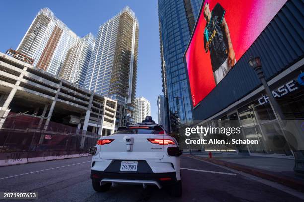 Los Angeles, CA A Waymo robotaxi Jaguar I-PACEs driverless car makes a stop in downtown Los Angeles Monday, March 11, 2024. Waymo is about to...