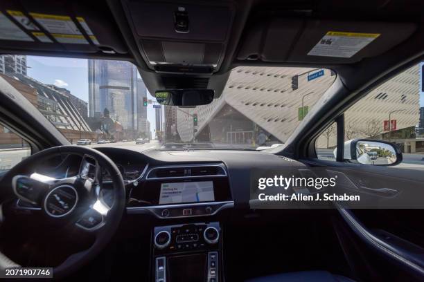 Los Angeles, CA A Waymo robotaxi Jaguar I-PACEs driverless car drives past The Broad in downtown Los Angeles Monday, March 11, 2024. Waymo is about...