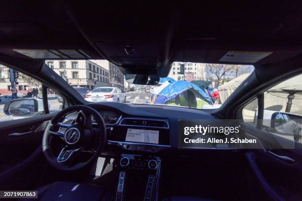 Los Angeles, CA A Waymo robotaxi Jaguar I-PACEs driverless car drives through Skid Row in downtown Los Angeles Monday, March 11, 2024. Waymo is about...