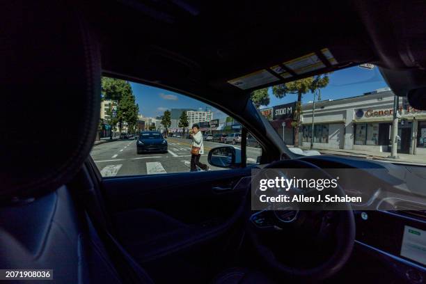 Los Angeles, CA A Waymo robotaxi Jaguar I-PACEs driverless car turns as a passenger crosses the crosswalk in downtown Los Angeles Monday, March 11,...