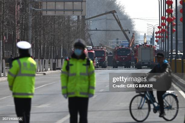 Firefighters work at the scene of a suspected gas explosion in Sanhe, in China's northern Hebei province on March 13, 2024. A huge suspected gas...