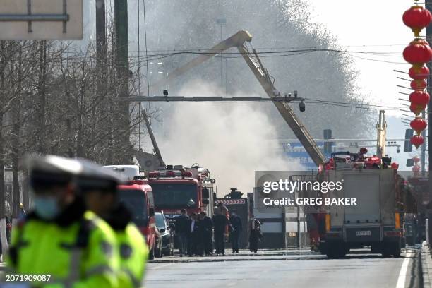 Firefighters work at the scene of a suspected gas explosion in Sanhe, in China's northern Hebei province on March 13, 2024. A huge suspected gas...