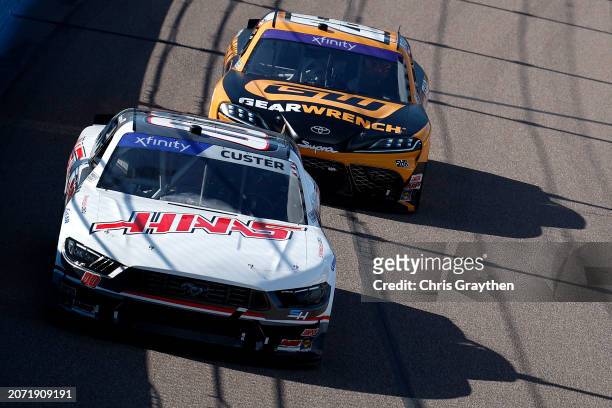 Cole Custer, driver of the Haas Automation Ford, and Corey Heim, driver of the GearWrench Toyota, race during the NASCAR Xfinity Series Call 811.com...