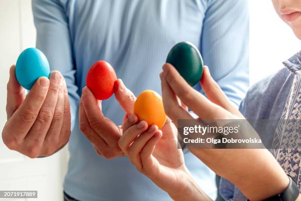 father and son holding dyed easter eggs in hands - championship day two stock pictures, royalty-free photos & images