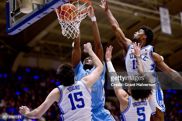 Jalen Washington of the North Carolina Tar Heels dunks over Ryan Young of the Duke Blue Devils during the first half of the game at Cameron Indoor...